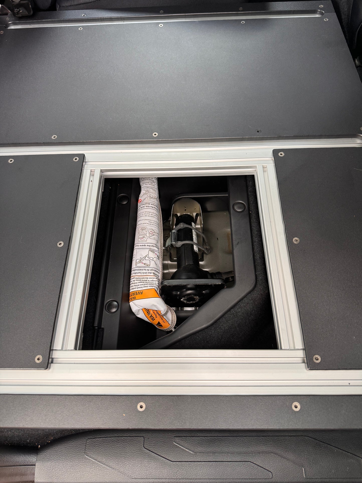 Tacoma 60% storage access hatch opened.