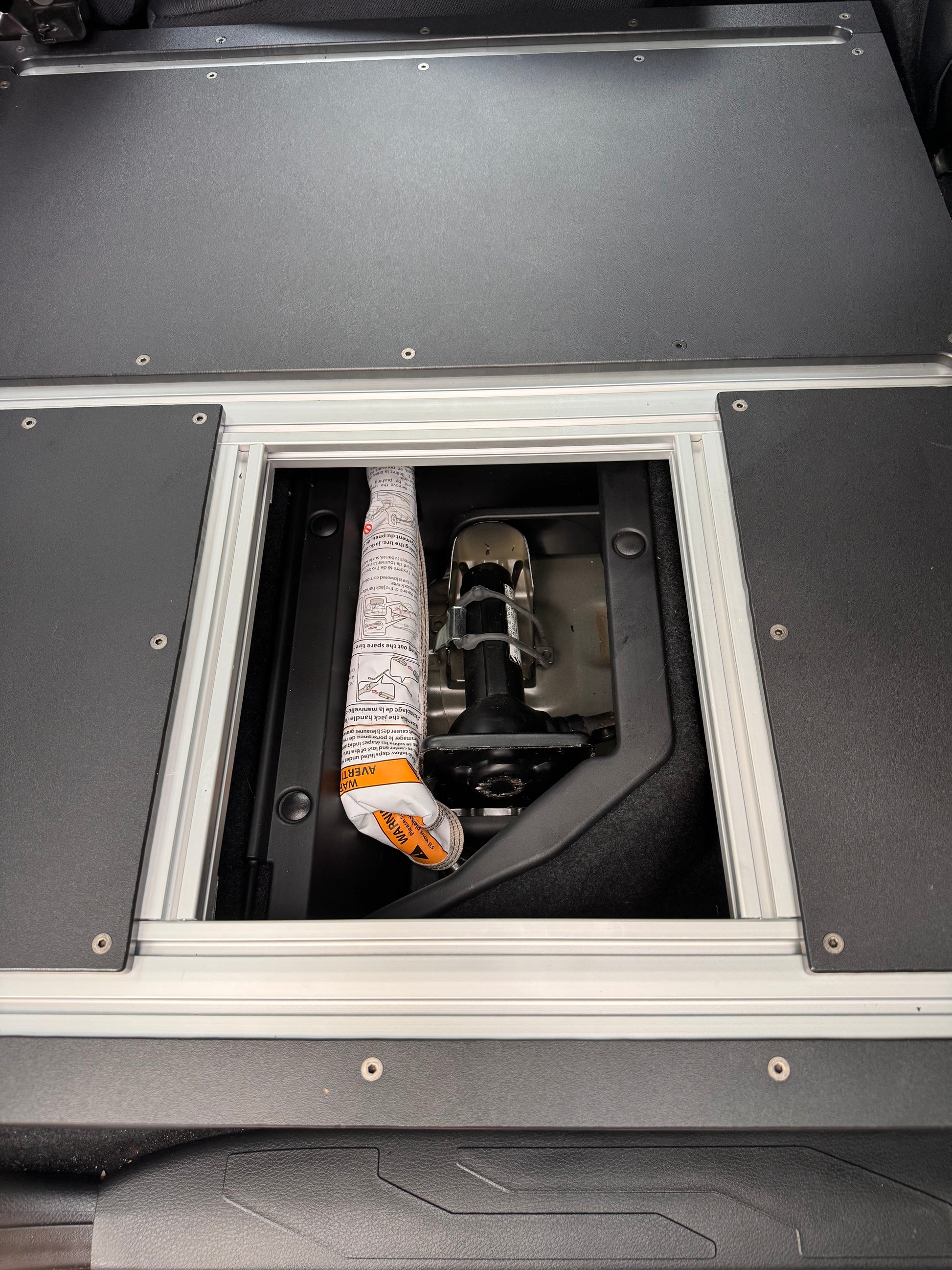 Tacoma 60% storage access hatch opened.