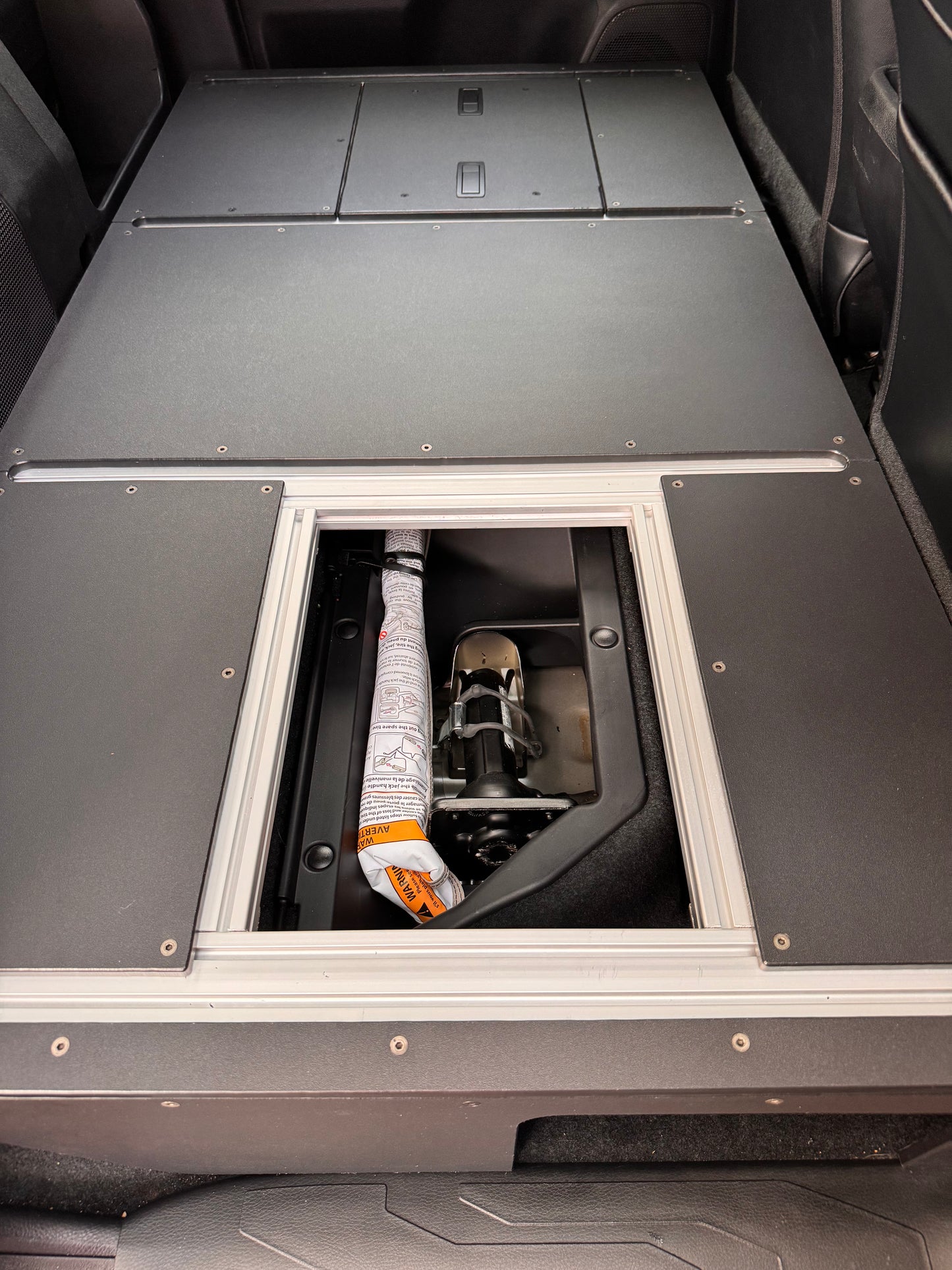 Tacoma full rear seat delete storage access hatch opened.