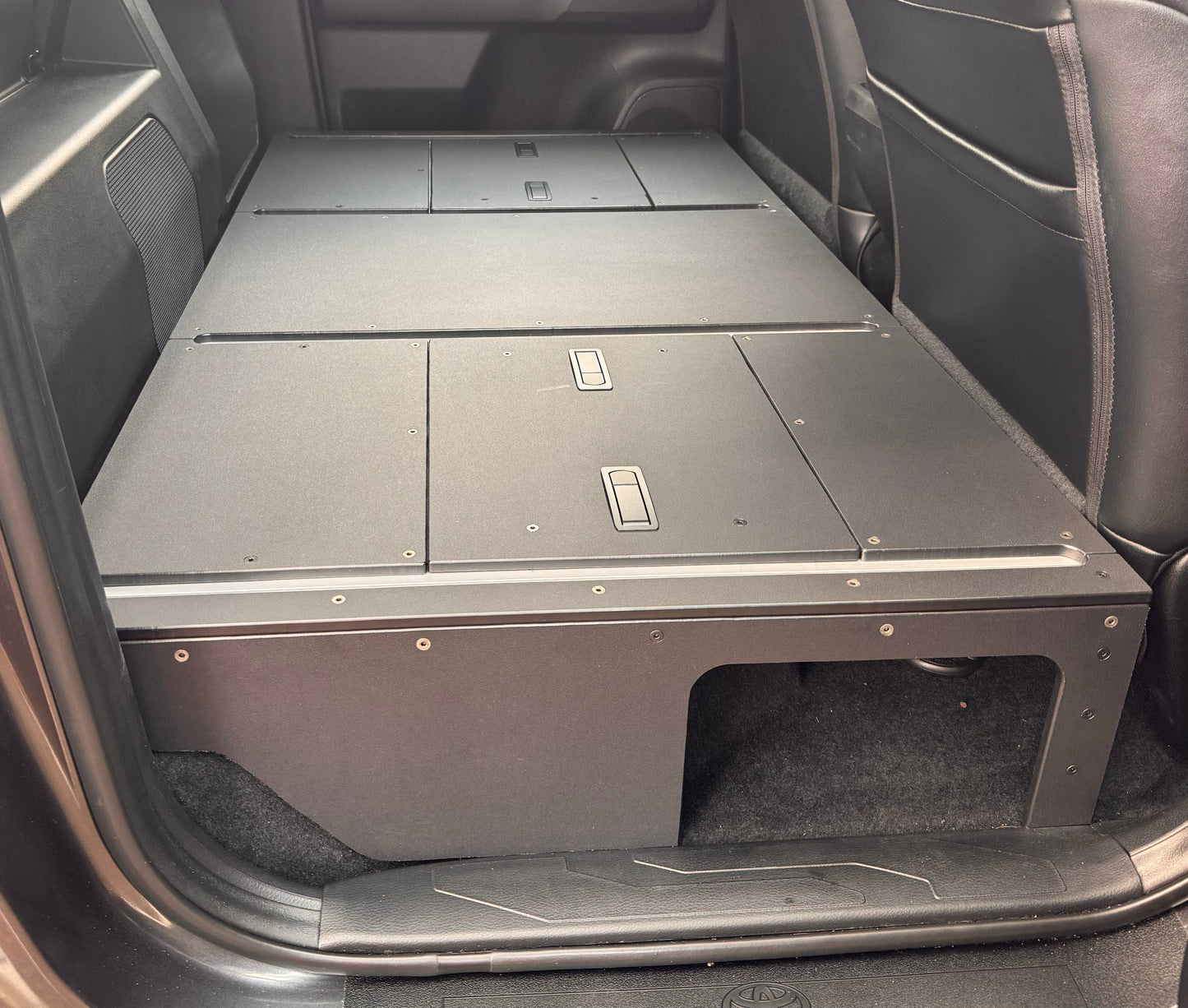 Toyota Tacoma Full Rear Seat Delete Kit, converting the rear seats into a flat cargo deck.